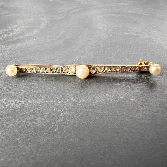 Antique Natural Pearl and Rose Cut Diamond Bar Brooch, set with three button-shape natural white pearls interspaced by 20 rose-cut and two old-cut diamonds in silver upon 18ct yellow gold
