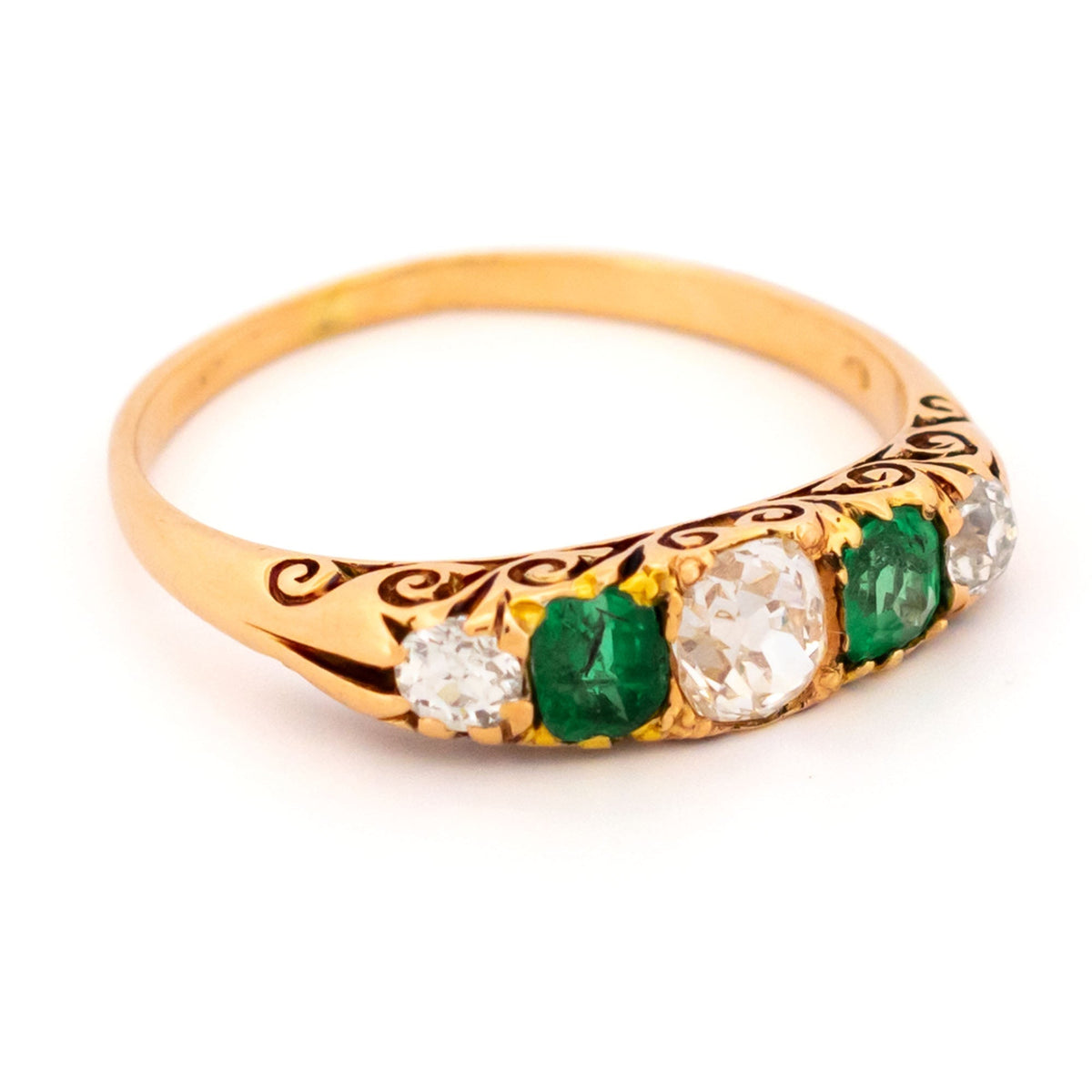 A five stone old cut emerald and diamond graduated ring in yellow gold