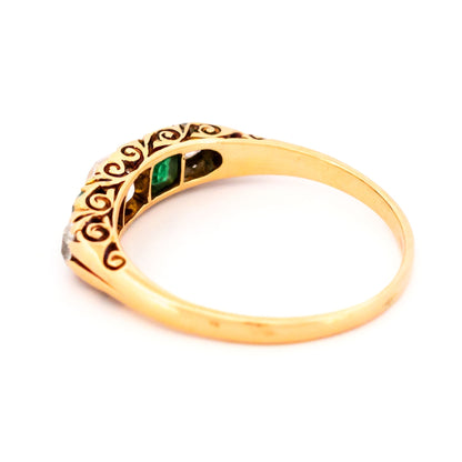 A five stone old cut emerald and diamond graduated ring in yellow gold
