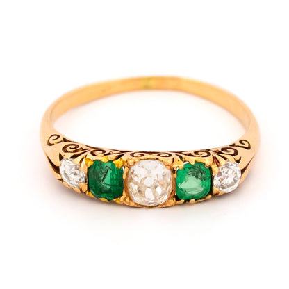 A five stone old cut emerald and diamond graduated ring in yellow gold