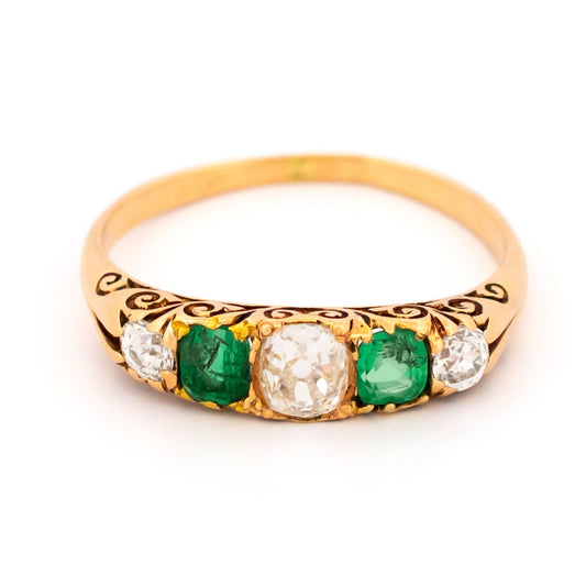A five stone old cut emerald and diamond graduated ring in yellow gold