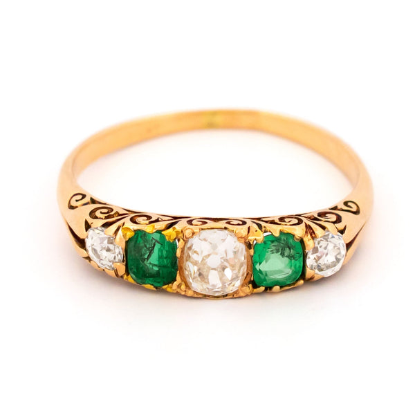 A five stone old cut emerald and diamond graduated ring in yellow gold