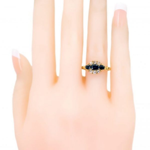 Antique Victorian Sapphire and Old Cut Diamond Ring; three sapphires surrounded by old mine-cut diamonds, 1.18 carat total, set in 18ct yellow gold.