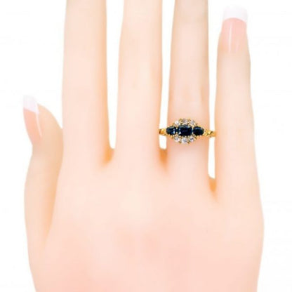 Antique Victorian Sapphire and Old Cut Diamond Ring; three sapphires surrounded by old mine-cut diamonds, 1.18 carat total, set in 18ct yellow gold.