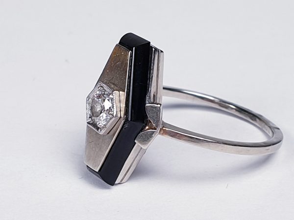 Art Deco French Old Cut Diamond and Onyx Lozenge Plaque Ring; hexagonal ring with central 0.25ct old cut diamond on a matt ground with a fine onyx border. Set in white gold, Circa 1925