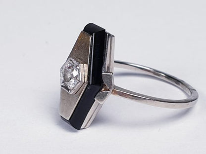 Art Deco French Old Cut Diamond and Onyx Lozenge Plaque Ring; hexagonal ring with central 0.25ct old cut diamond on a matt ground with a fine onyx border. Set in white gold, Circa 1925