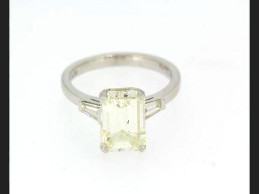 Emerald cut diamond ring with diamond shoulders, set in hallmarked 18ct white gold. Central diamond is an EC diamond, 3.21 carats, colour J, clarity VS2