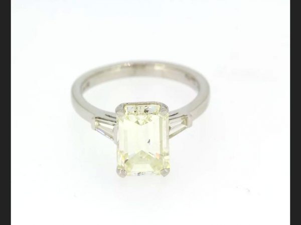 Emerald cut diamond ring with diamond shoulders, set in hallmarked 18ct white gold. Central diamond is an EC diamond, 3.21 carats, colour J, clarity VS2