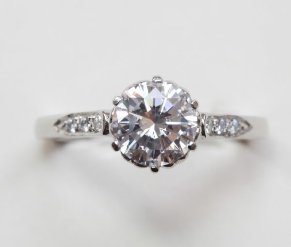 Diamond and Platinum Solitaire Engagement Ring; internally flawless 1.28ct round brilliant-cut diamond, colour D, with HRD certificate, flanked by brilliant cut diamonds, heart decorated mount