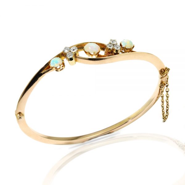 Antique Victorian Opal and Diamond Bangle Bracelet, 15ct yellow gold bangle set with 1.20cts opals and 0.42cts old-cut diamonds. Made in England, Circa 1860s