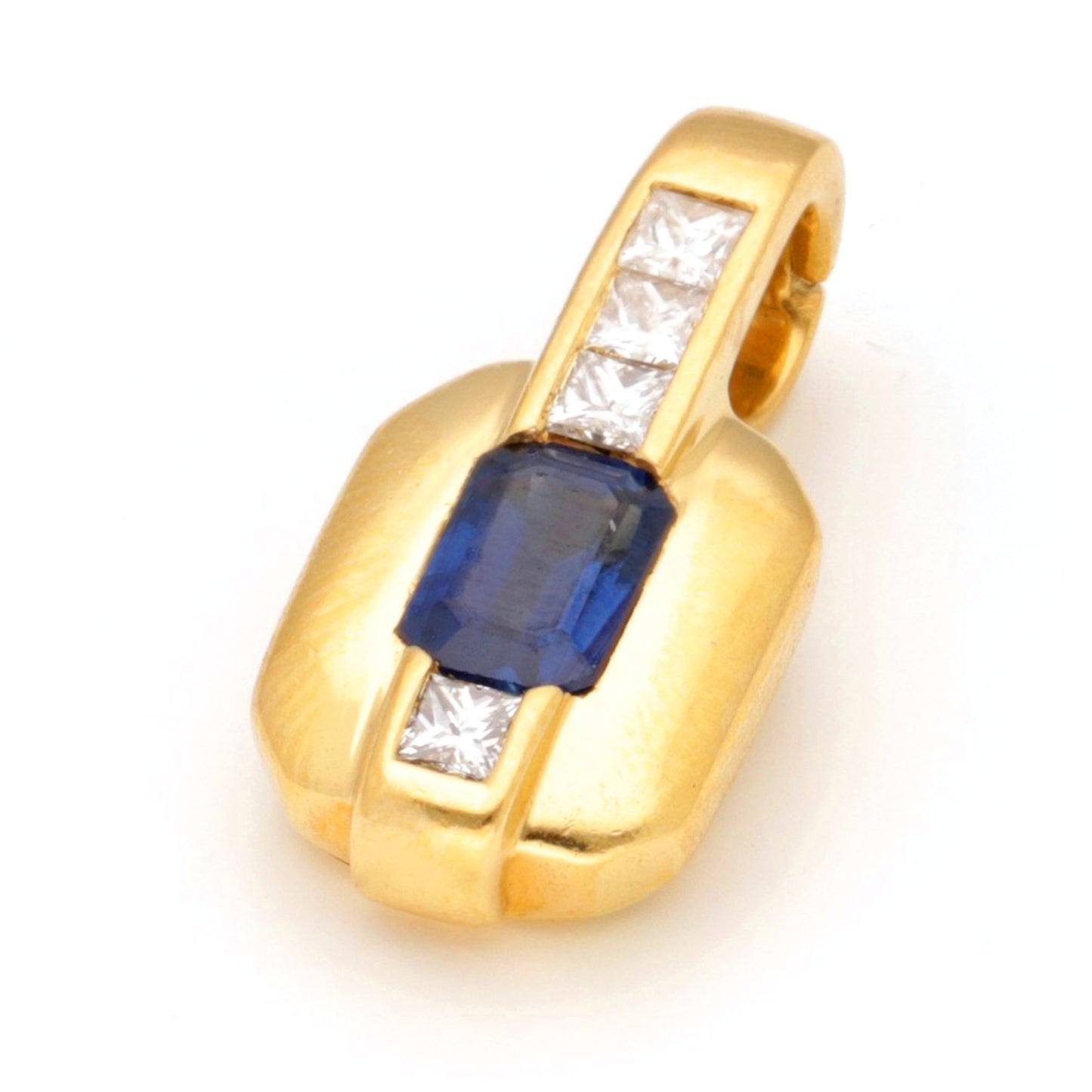 A yellow gold pendant with an octagonal cut sapphire and four princess cut diamonds, against a white background