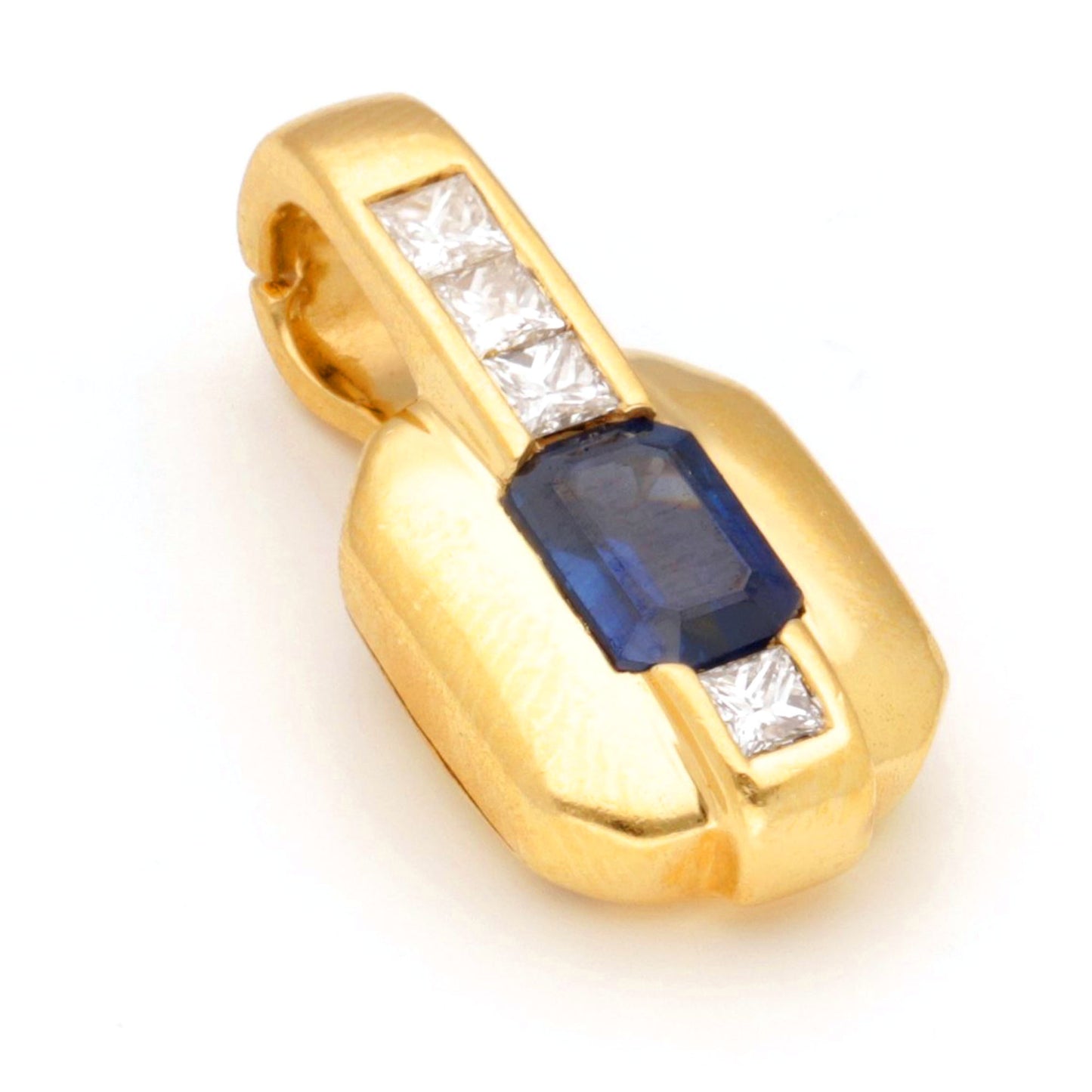 A yellow gold pendant with an octagonal cut sapphire and four princess cut diamonds, against a white background
