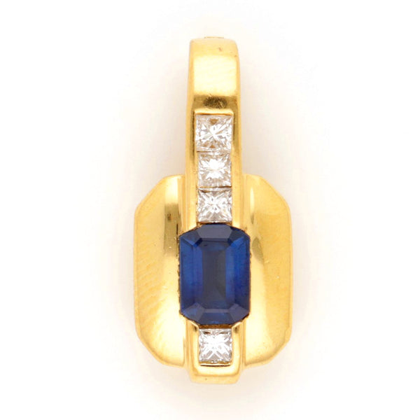 A yellow gold pendant with an octagonal cut sapphire and four princess cut diamonds, against a white background