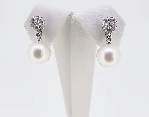 South Sea Pearl and Diamond Drop Earrings; featuring South Sea pearls suspended from cluster diamond studs. Mounted in 18ct white gold.