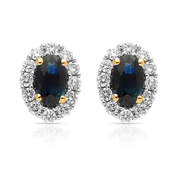 A pair of oval shaped sapphire and diamond cluster earrings in yellow and white gold, against a white background