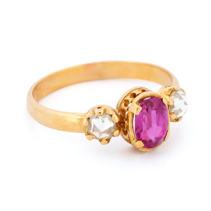 A three stone oval ruby and rose cut diamond ring in yellow gold