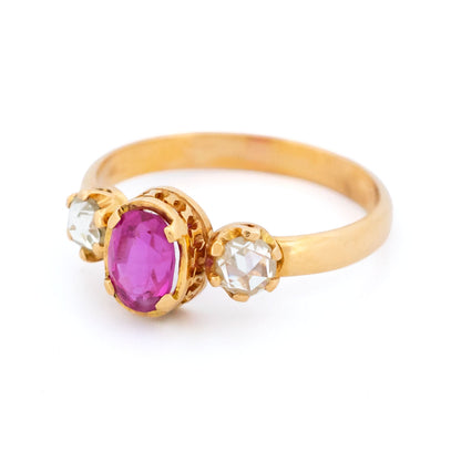 A three stone oval ruby and rose cut diamond ring in yellow gold