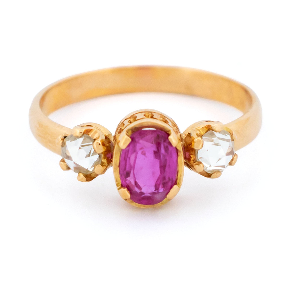 A three stone oval ruby and rose cut diamond ring in yellow gold