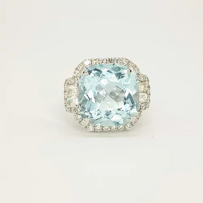 Cushion Cut Aquamarine and Diamond Cluster Ring; central 9.91 carat square cushion aquamarine surrounded by diamonds, with modified square step-cut diamonds to the shoulders, in 18ct white gold