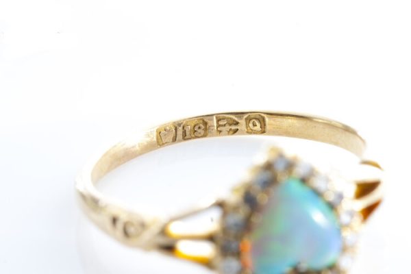 Antique Victorian Opal and Rose Cut Diamond Heart Cluster Ring; 0.75ct heart shaped opal surrounded by 0.36cts rose cut diamonds, 18ct yellow gold, Circa 1865