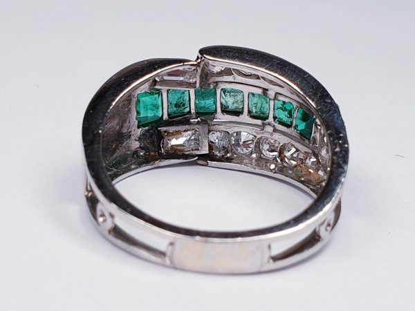 Vintage Emerald and Diamond Asymmetric Geometric Band Ring; set with 0.70cts graduated square step-cut emeralds encompassed by an asymmetric 1.40cts diamond surround. Mounted in Platinum and 18ct White Gold. Circa 1940s