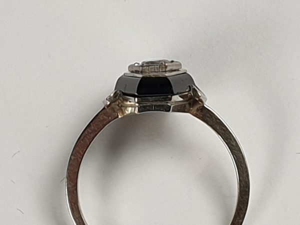 Art Deco French Old Cut Diamond and Onyx Lozenge Plaque Ring; hexagonal ring with central 0.25ct old cut diamond on a matt ground with a fine onyx border. Set in white gold, Circa 1925