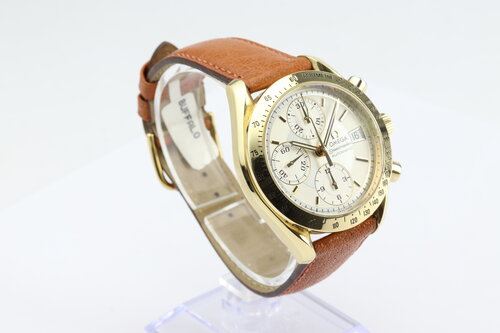 Omega Speedmaster 39mm Automatic Chronograph 18ct Yellow Gold, Silver and white baton dial, date indicator at 3, small seconds at 9, on brown leather strap.