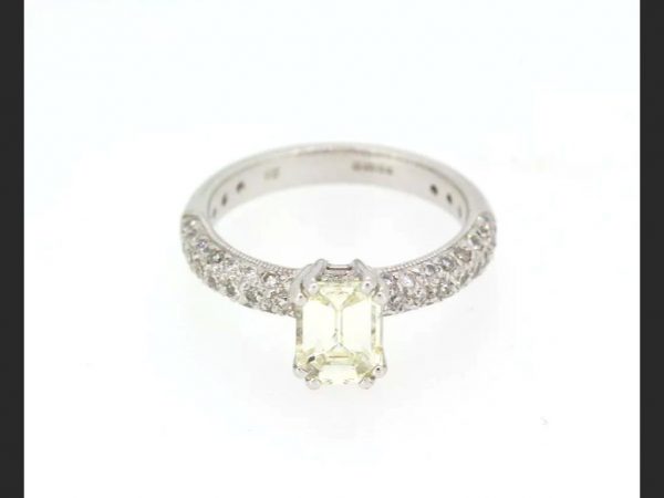 Emerald Cut Diamond Ring; Central emerald cut 1.00 carat diamond, with pave set shoulders totaling 0.55 carats, Hallmarked 18ct white gold