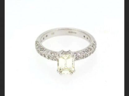 Emerald Cut Diamond Ring; Central emerald cut 1.00 carat diamond, with pave set shoulders totaling 0.55 carats, Hallmarked 18ct white gold