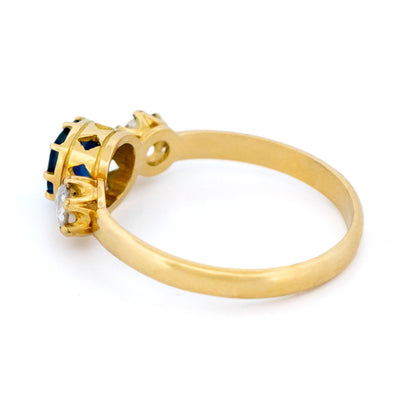 A sapphire and rose cut diamond three stone ring in yellow gold