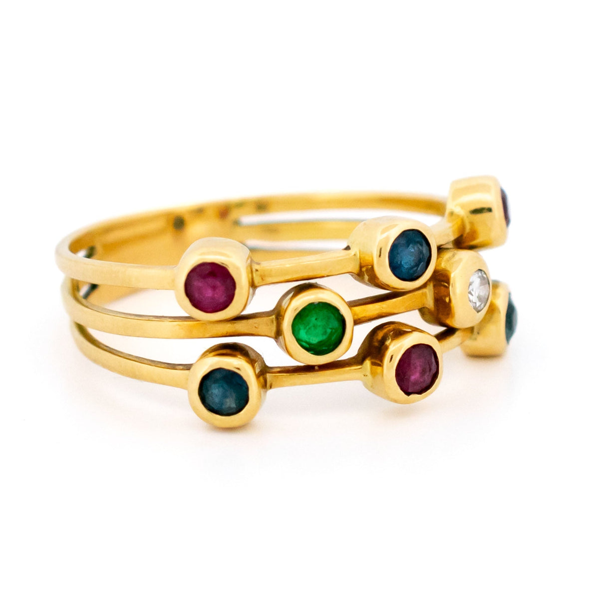 A multi-band ring in yellow gold set with round sapphires, rubies, an emerald and a diamond