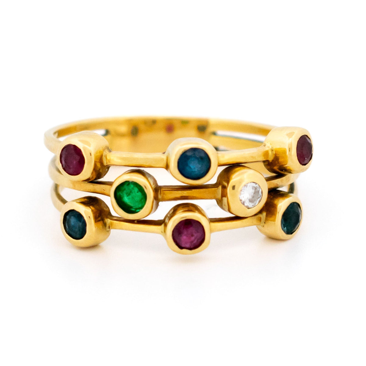 A multi-band ring in yellow gold set with round sapphires, rubies, an emerald and a diamond