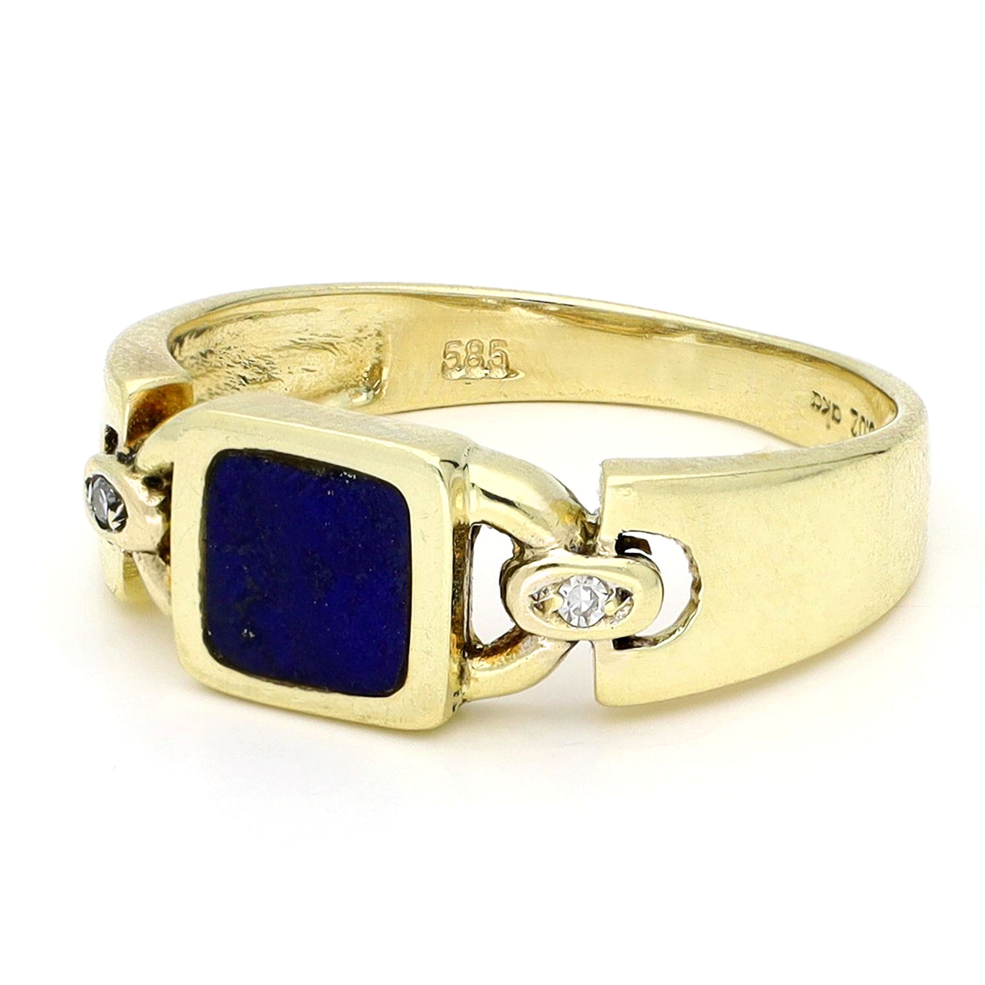 A square lapis lazuli and round diamond three stone ring in yellow gold, stamped 585, against a white background