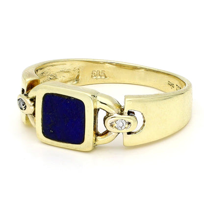 A square lapis lazuli and round diamond three stone ring in yellow gold, stamped 585, against a white background