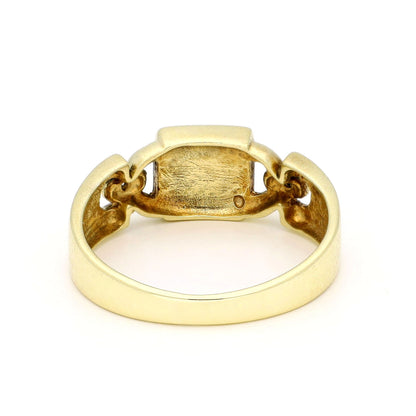 A yellow gold ring, against a white background