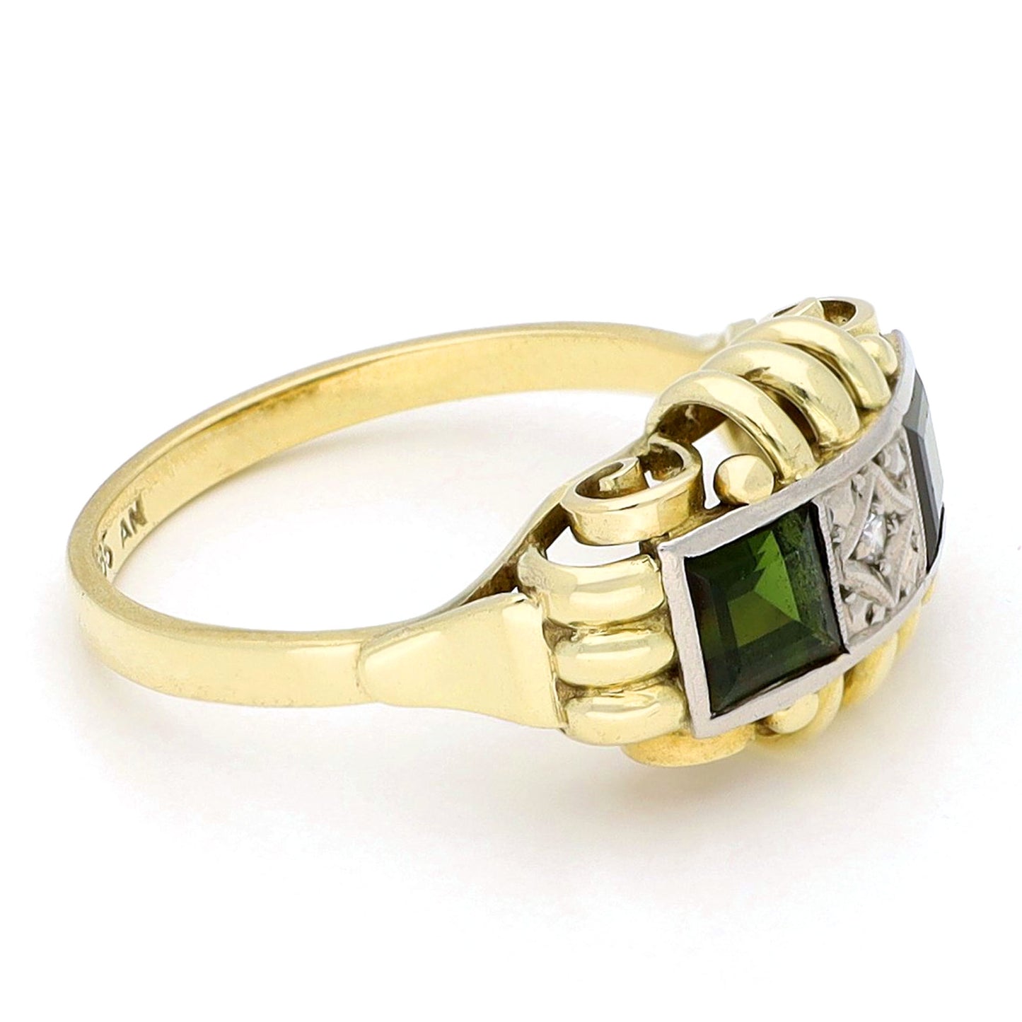 Square green tourmaline and round diamond ring in yellow and white gold, against a white background