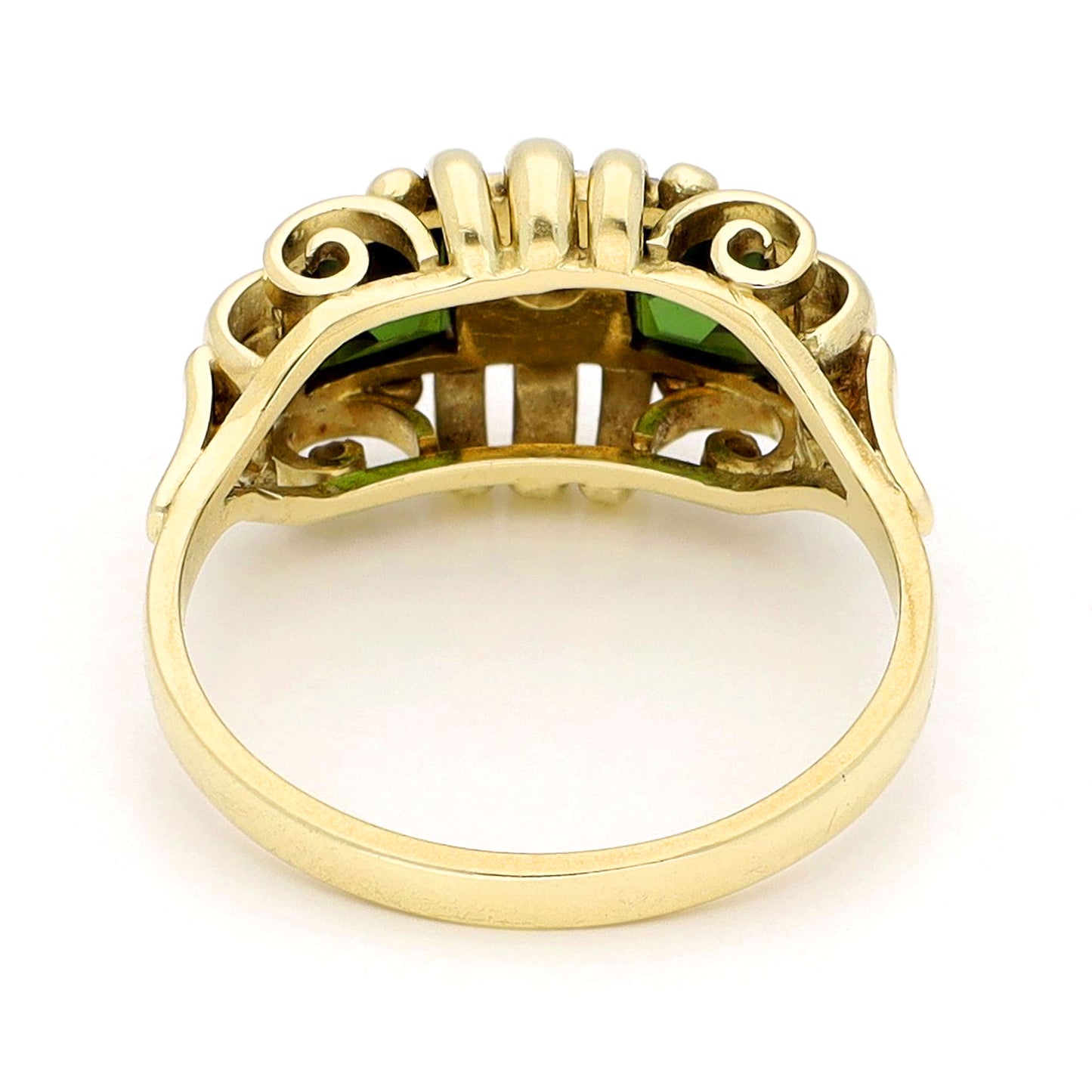 Square green tourmaline and round diamond ring in yellow and white gold, against a white background