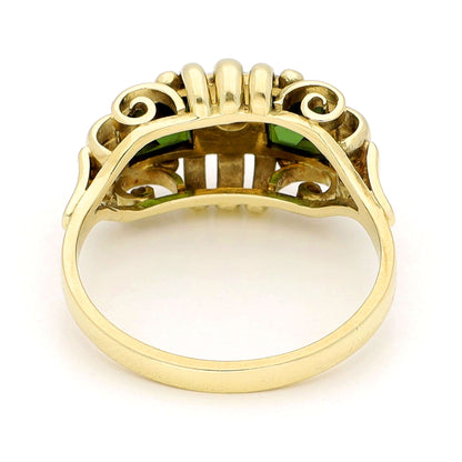 Square green tourmaline and round diamond ring in yellow and white gold, against a white background