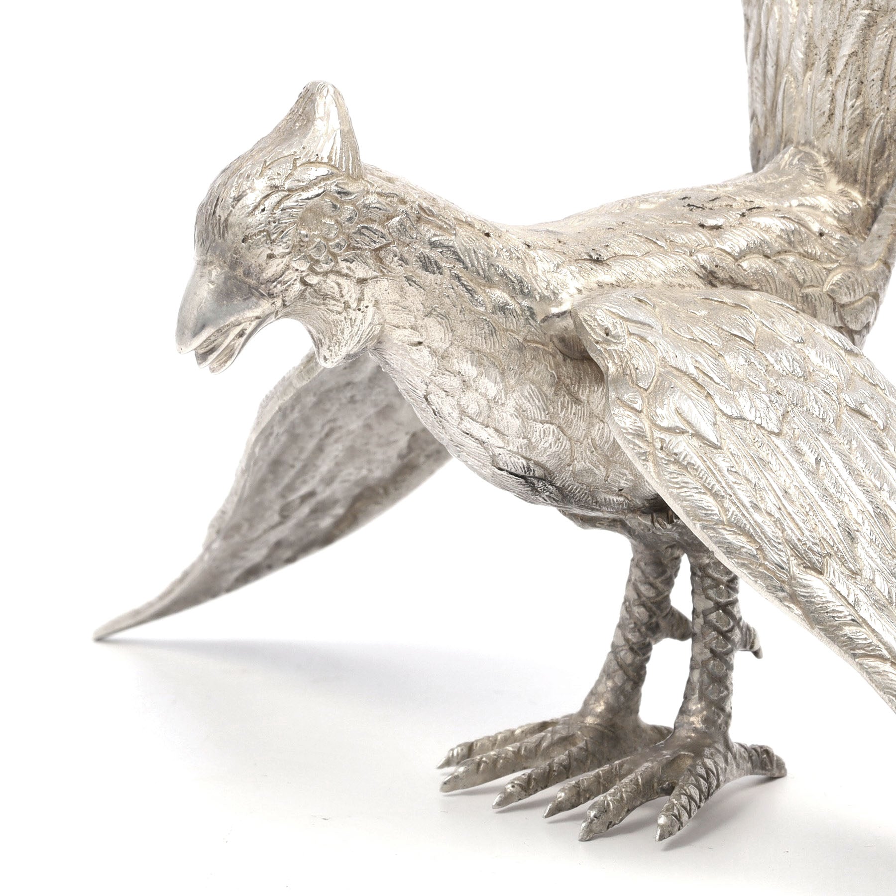 Silver bird figurine on a white background