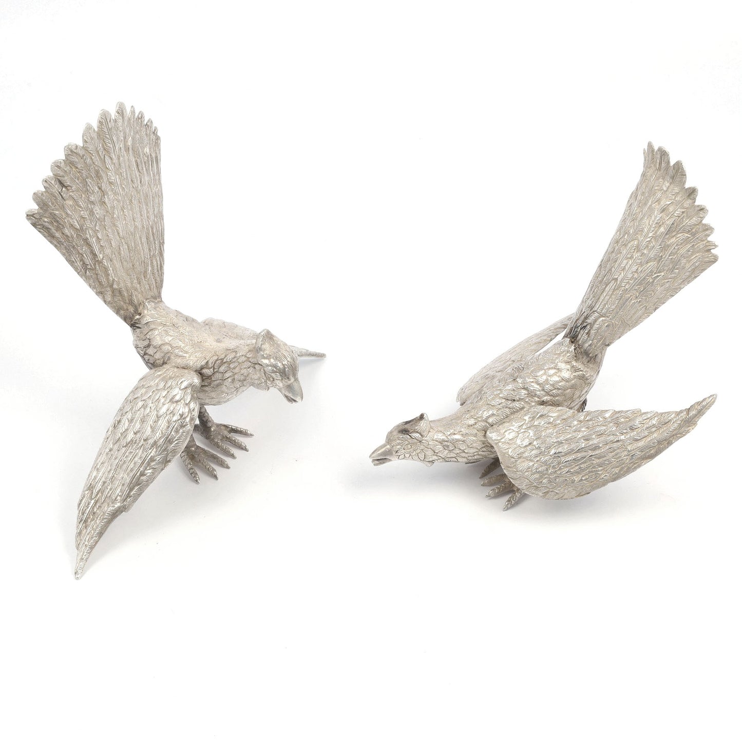Two silver bird figurines on a white background