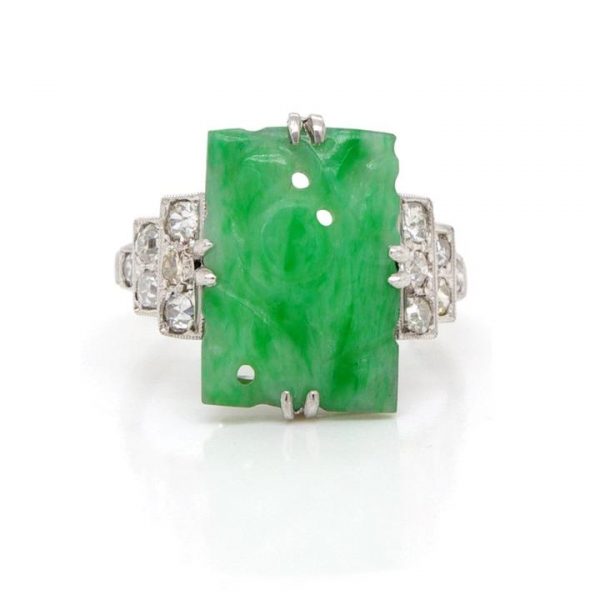 Art Deco Jade and Diamond Dress Ring; pierced carved rectangular piece of jadeite with stepped 0.40ct diamond-set shoulders, in platinum and 18ct white gold, Circa 1920