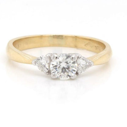 Brilliant and Trilliant Cut Diamond Three Stone Ring; central 0.40ct round brilliant cut diamond, flanked to either side by a trilliant cut diamond, 18ct gold