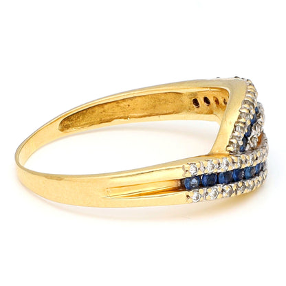 A sapphire and diamond crossover band ring in yellow gold