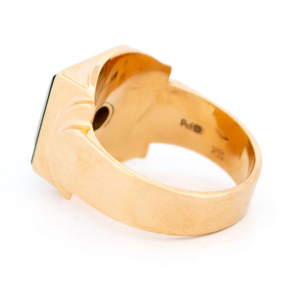 A yellow and white gold signet style ring with a square panel of black onyx and round diamonds