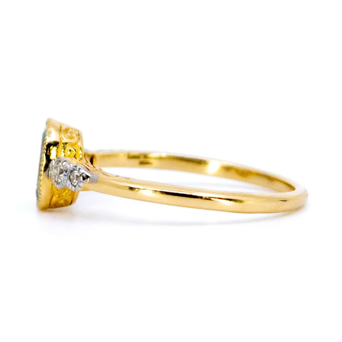 An oval aquamarine and round diamond ring in yellow and white gold