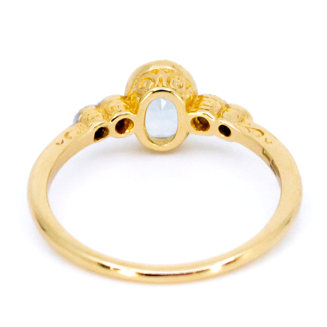 An oval aquamarine and round diamond ring in yellow and white gold