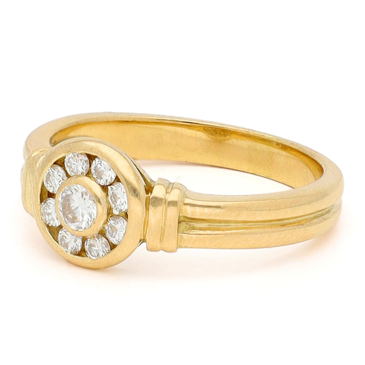 A yellow gold brilliant cut diamond rubover set cluster ring