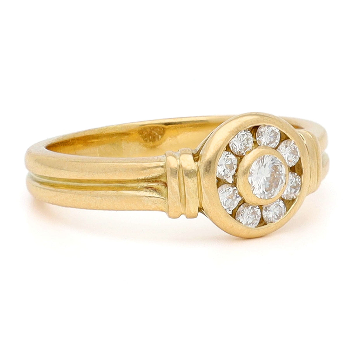 A yellow gold brilliant cut diamond rubover set cluster ring