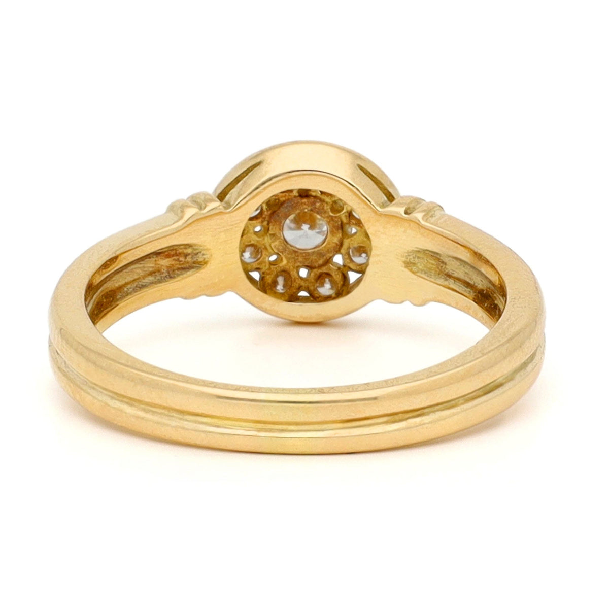 A yellow gold brilliant cut diamond rubover set cluster ring