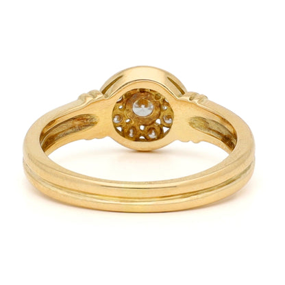 A yellow gold brilliant cut diamond rubover set cluster ring